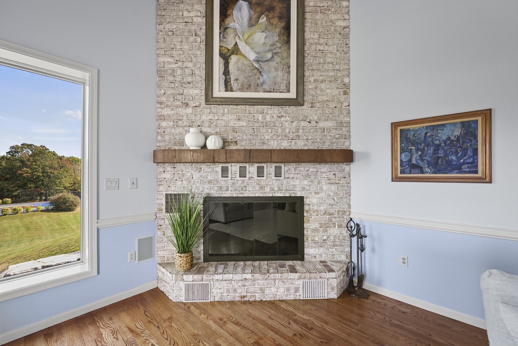 60 Old Cheshire Road Lanesborough, MA 01237 - Photo 12 of 42 a living room with a fireplace and a wooden floor