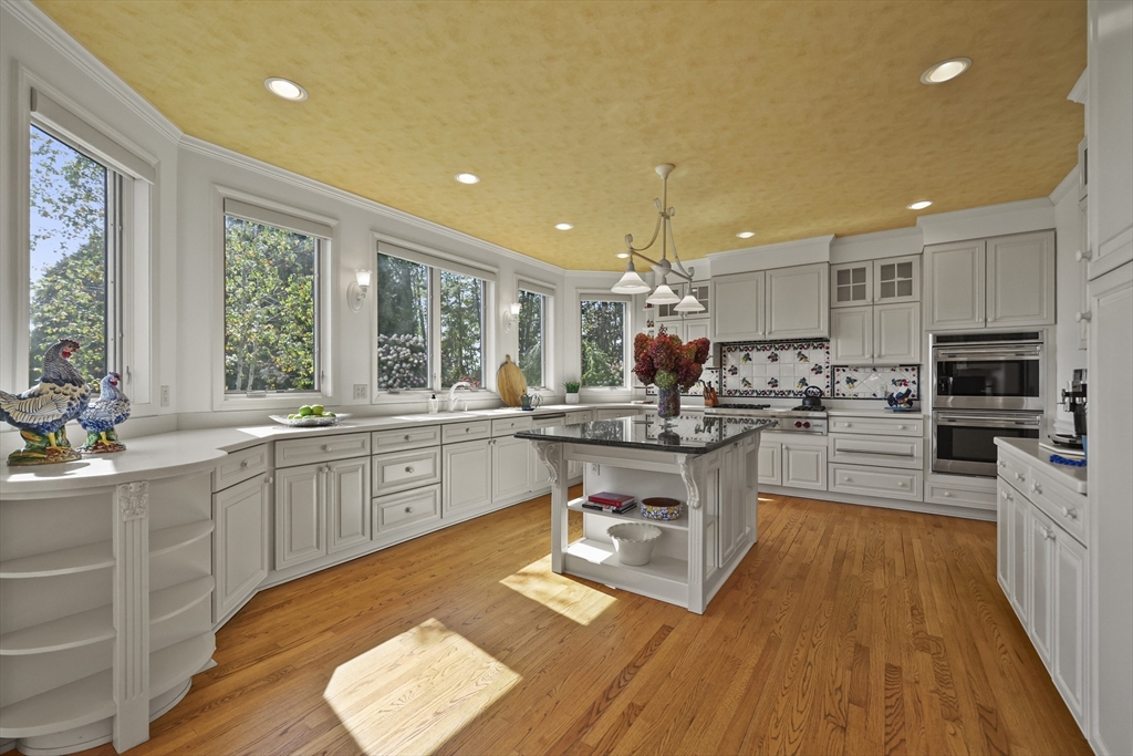 60 Old Cheshire Road Lanesborough, MA 01237 - Photo 24 of 42 a kitchen with stainless steel appliances granite countertop wooden cabinets a sink dishwasher a stove and a dining table with wooden floor