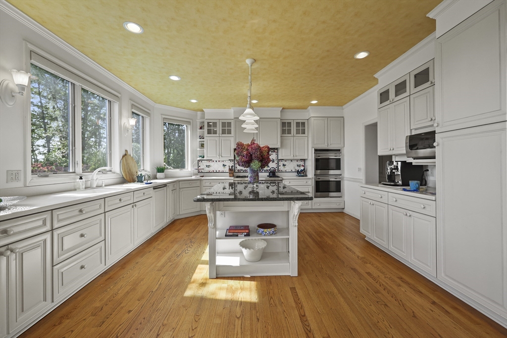60 Old Cheshire Road Lanesborough, MA 01237 - Photo 25 of 42 a large kitchen with white cabinets and stainless steel appliances