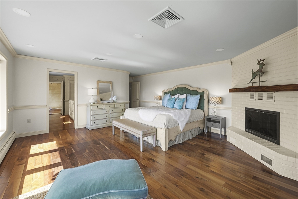 60 Old Cheshire Road Lanesborough, MA 01237 - Photo 30 of 42 a spacious bedroom with a bed and a fireplace