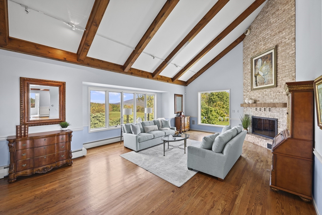 60 Old Cheshire Road Lanesborough, MA 01237 - Photo 8 of 42 a living room with fireplace furniture and a wooden floor