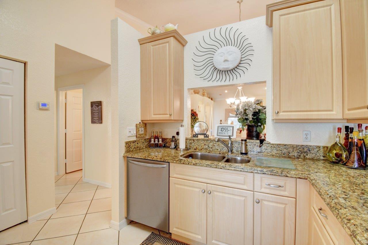 6104 Caladium Road Delray Beach, FL 33484 - Photo 13 of 43 a kitchen with a sink and cabinets
