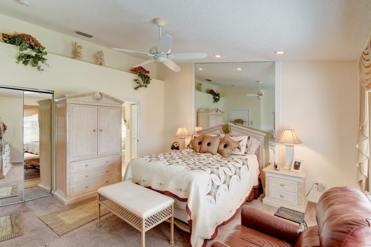 6104 Caladium Road Delray Beach, FL 33484 - Photo 17 of 43 a bedroom with a bed couch and a view of bathroom