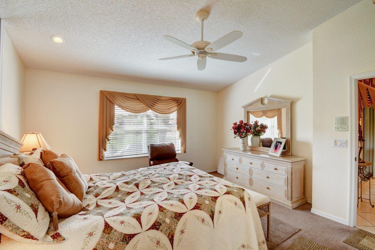 6104 Caladium Road Delray Beach, FL 33484 - Photo 18 of 43 a bedroom with a bed and a window