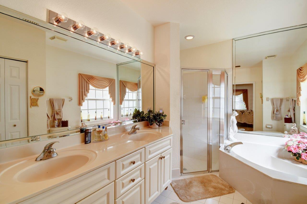 6104 Caladium Road Delray Beach, FL 33484 - Photo 20 of 43 a bathroom with a tub sink and mirror