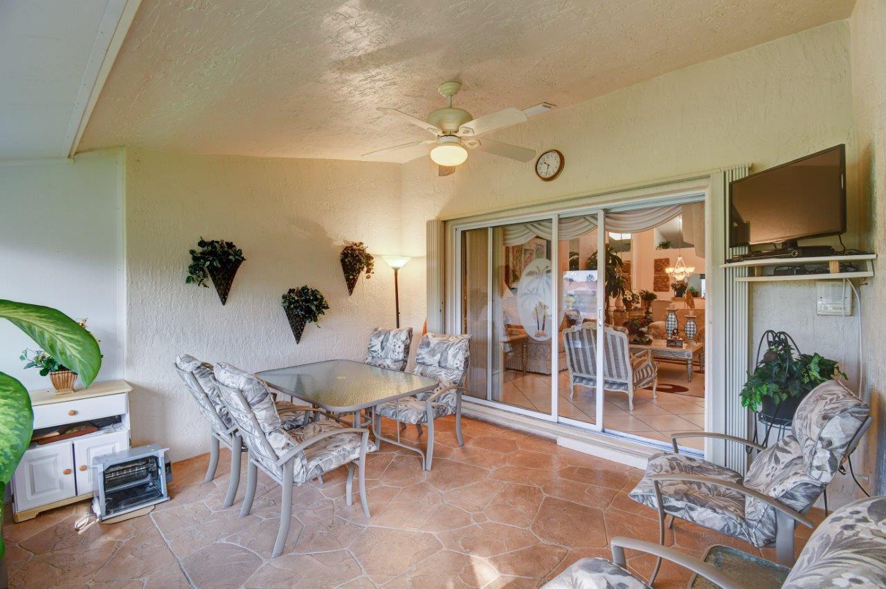6104 Caladium Road Delray Beach, FL 33484 - Photo 22 of 43 a living room with furniture a dining table and a potted plant
