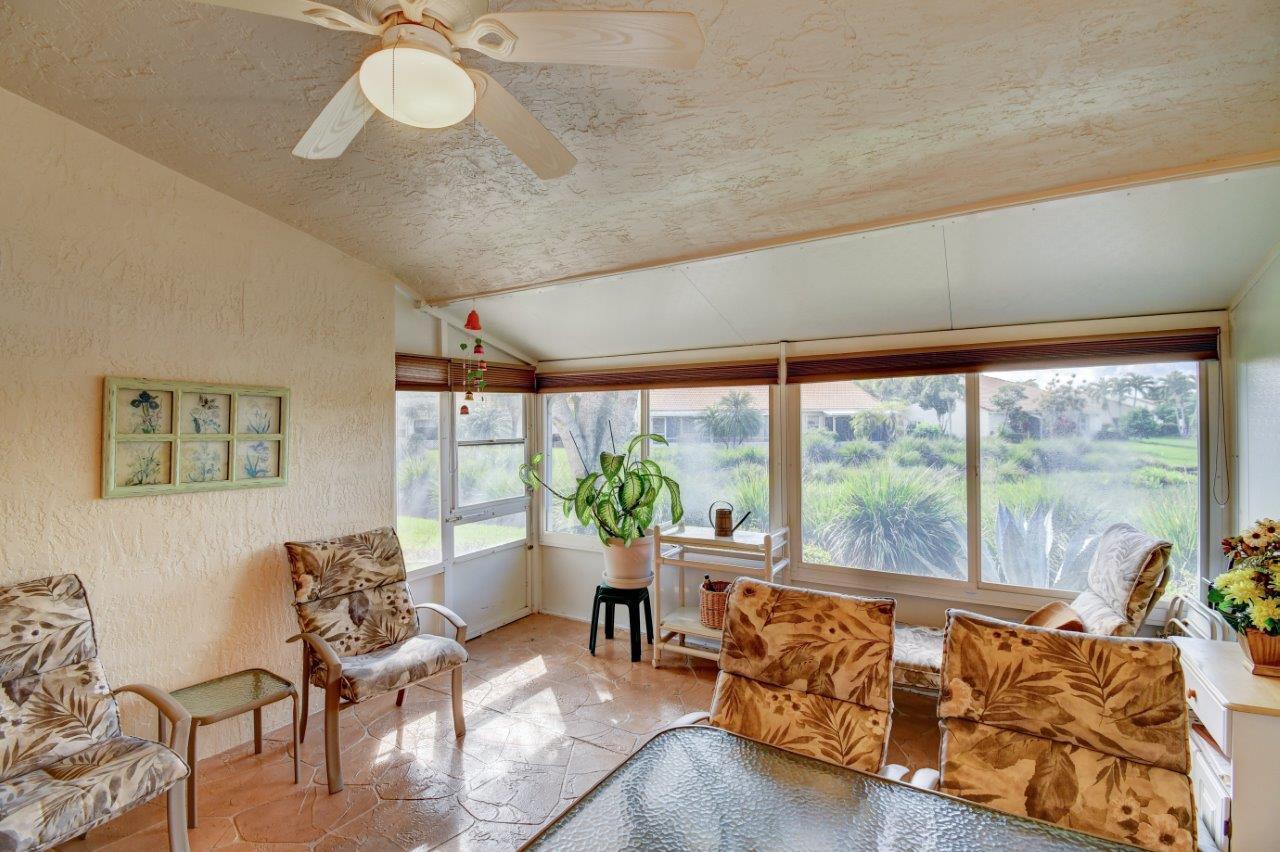 6104 Caladium Road Delray Beach, FL 33484 - Photo 23 of 43 a living room with furniture and a large window
