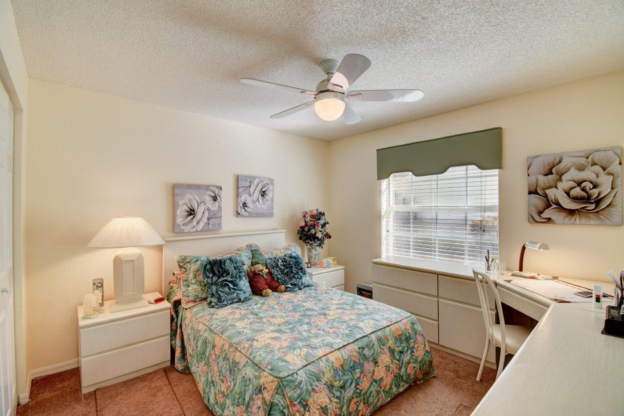 6104 Caladium Road Delray Beach, FL 33484 - Photo 24 of 43 a bedroom with a bed and a table