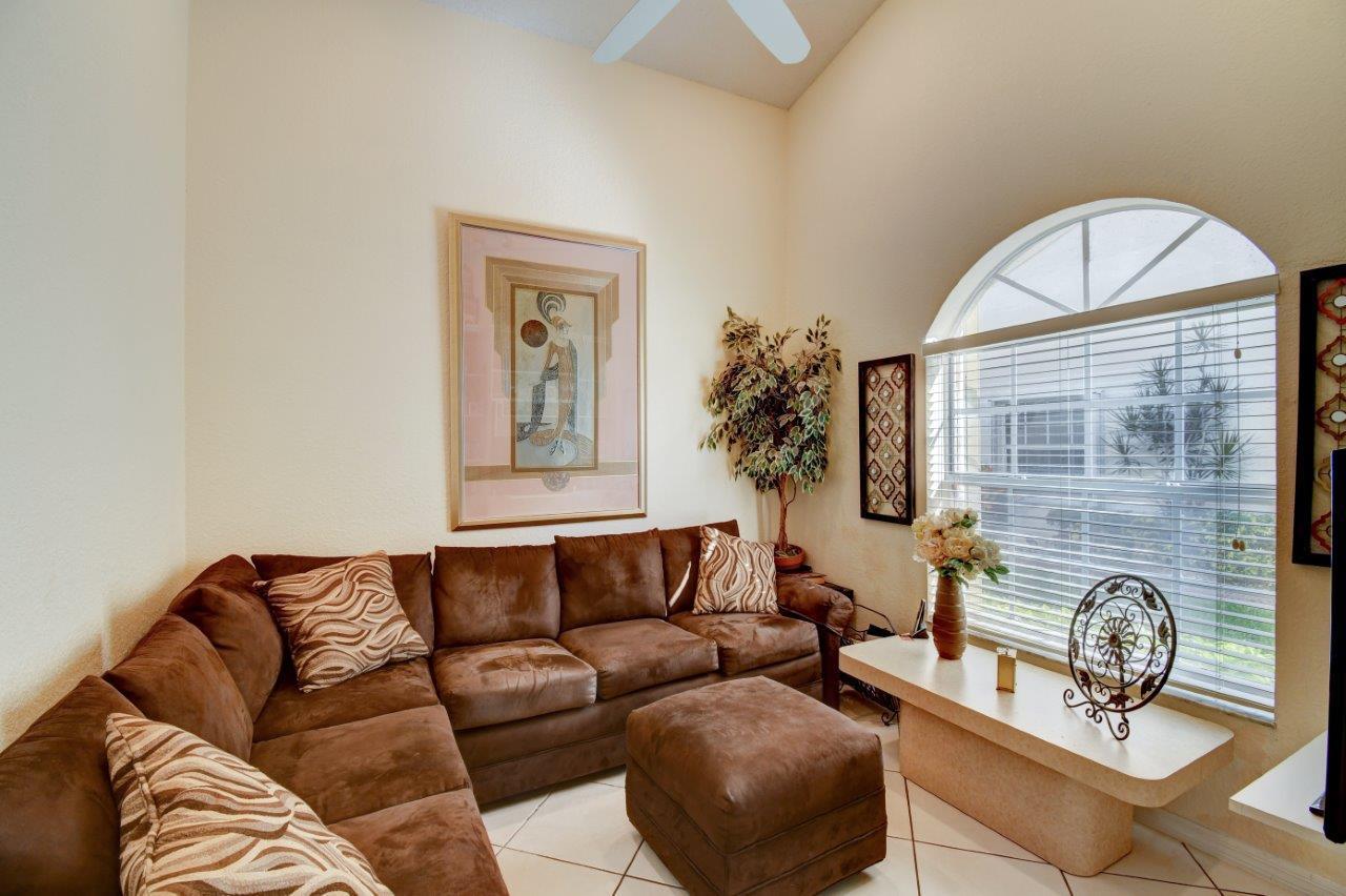 6104 Caladium Road Delray Beach, FL 33484 - Photo 29 of 43 a living room with furniture and a large window