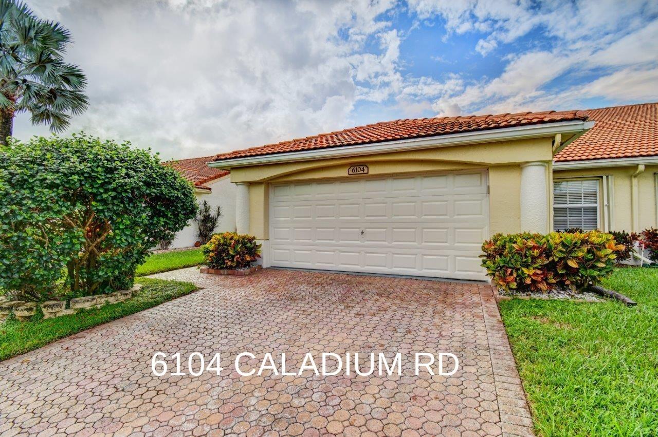 6104 Caladium Road Delray Beach, FL 33484 - Photo 3 of 43 a front view of house with a garden