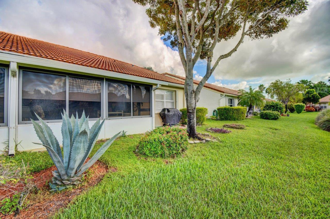 6104 Caladium Road Delray Beach, FL 33484 - Photo 31 of 43 a front view of a house with garden