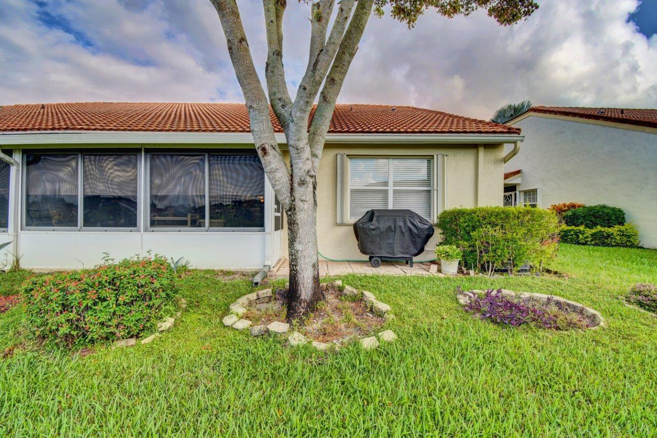6104 Caladium Road Delray Beach, FL 33484 - Photo 32 of 43 a front view of a house with a yard