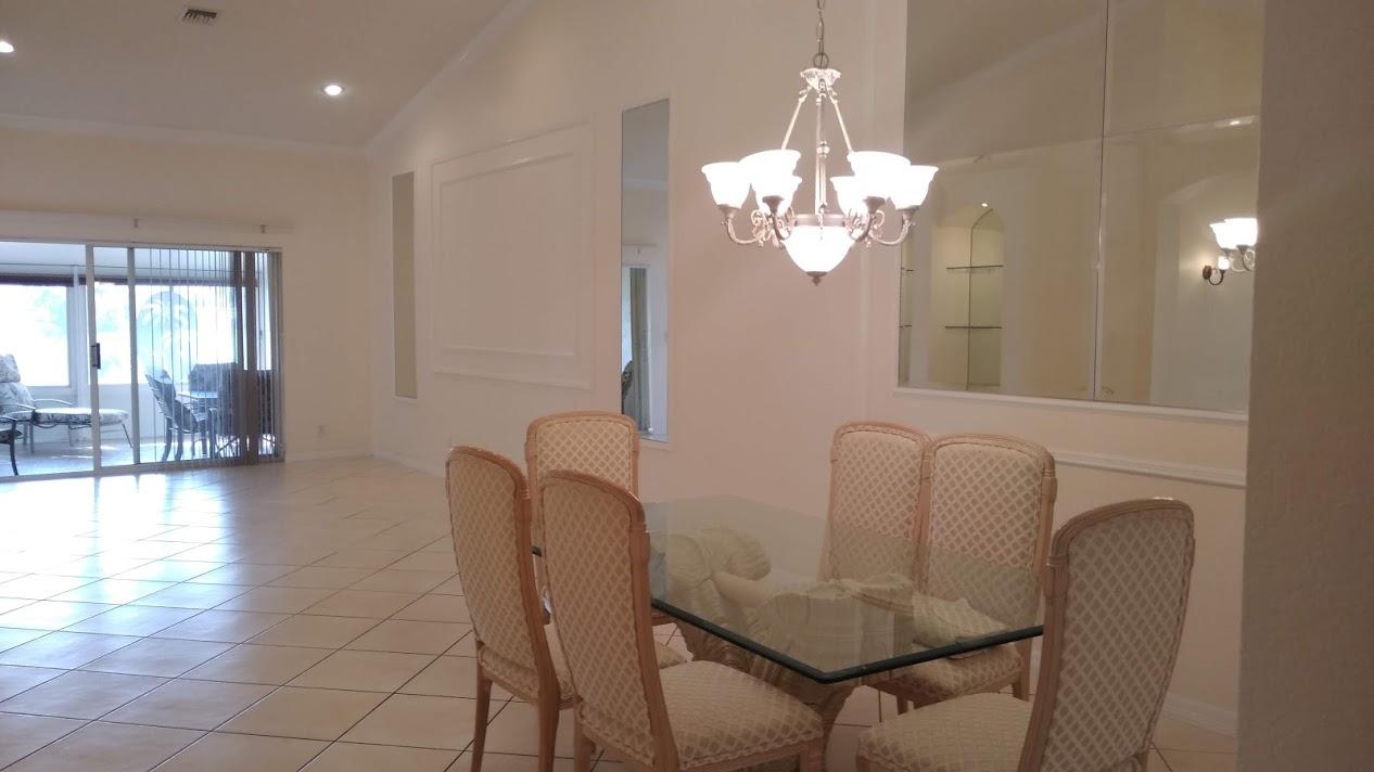 6104 Caladium Road Delray Beach, FL 33484 - Photo 40 of 43 a view of a dining room with furniture and chandelier