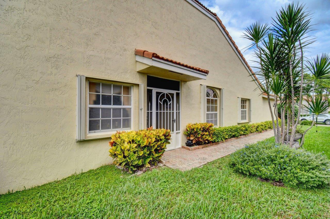 6104 Caladium Road Delray Beach, FL 33484 - Photo 4 of 43 front view of a house with a yard
