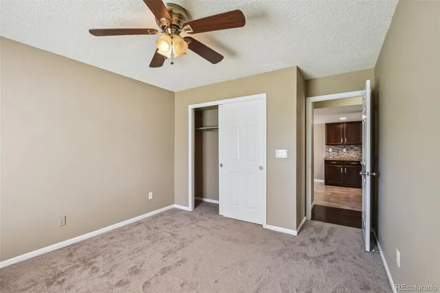 an empty room and chandelier fan