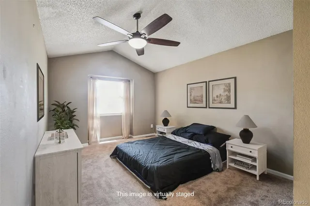a bedroom with a bed couch and window