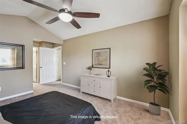 a bedroom with a bed and a potted plant