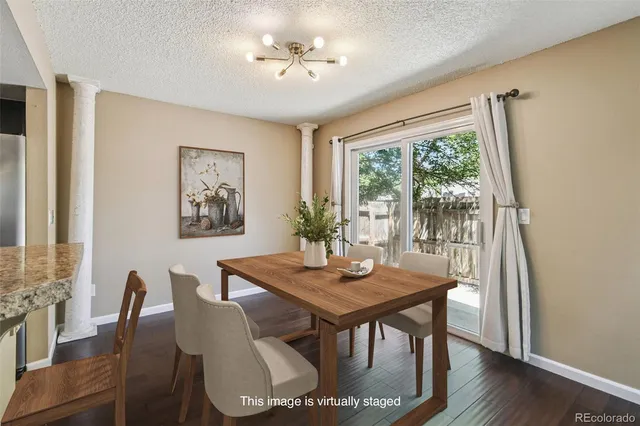a view of a dining room with furniture window and wooden floor