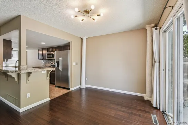 a view of a kitchen with wooden floor and a kitchen