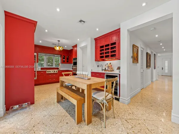 a room with stainless steel appliances kitchen island granite countertop furniture and a view of kitchen