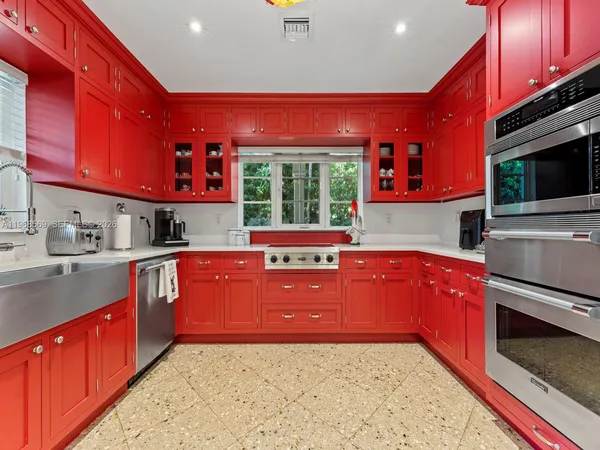 a kitchen with stainless steel appliances granite countertop a stove a sink dishwasher a microwave oven with granite countertops and cabinets