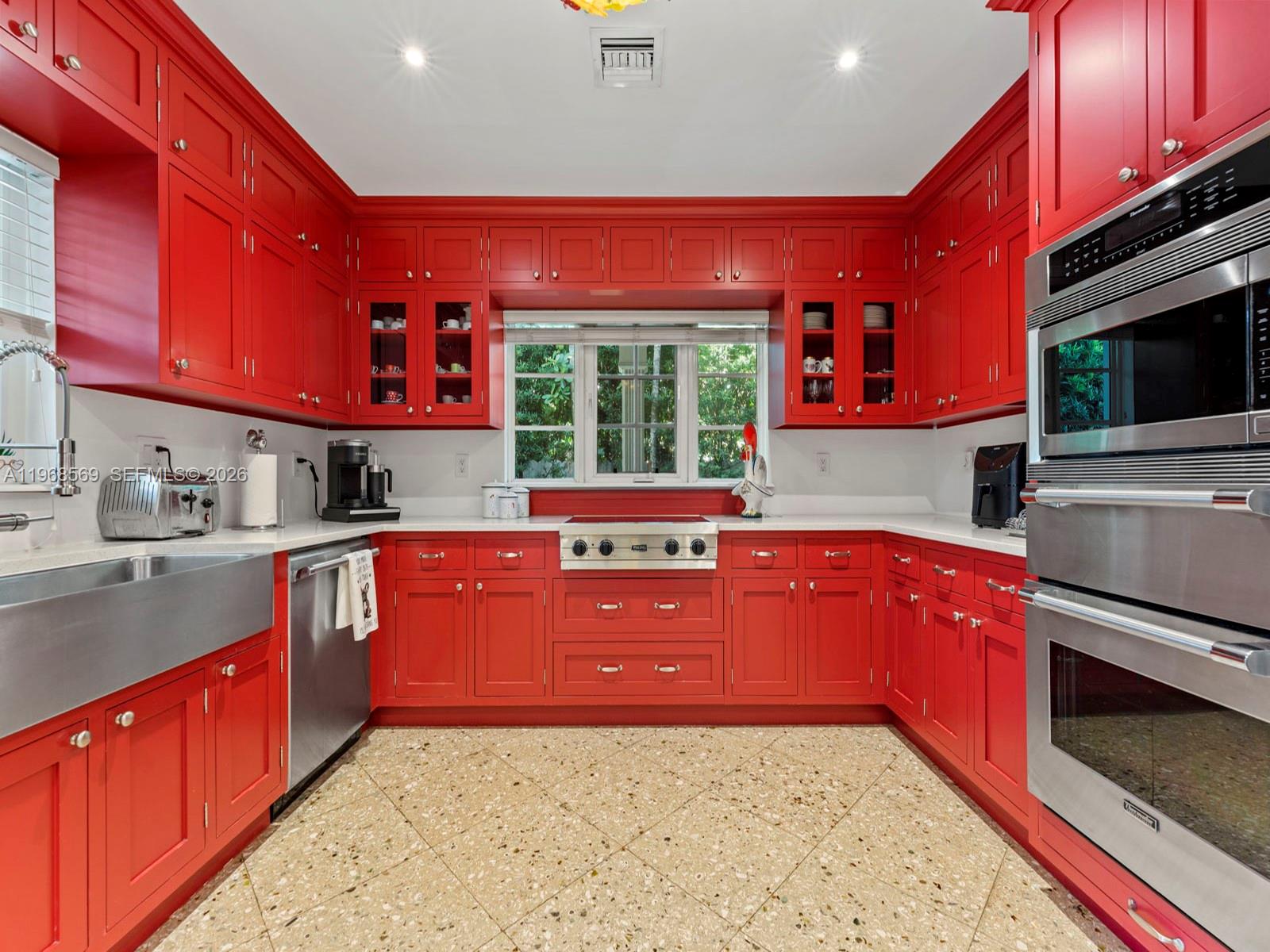 7218 Southwest 54th Court Miami, FL 33143 - Photo 23 of 47 a kitchen with stainless steel appliances granite countertop a stove a sink dishwasher a microwave oven with granite countertops and cabinets