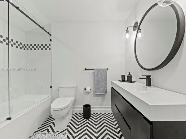 a bathroom with a sink a toilet and a mirror