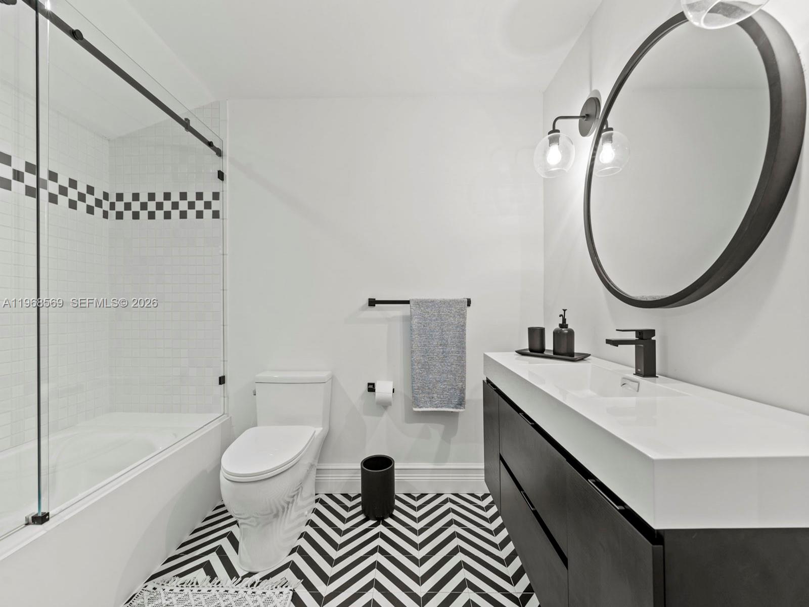 7218 Southwest 54th Court Miami, FL 33143 - Photo 26 of 47 a bathroom with a sink a toilet and a mirror