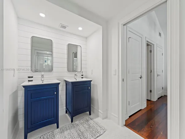 a spacious bathroom with a sink and a mirror