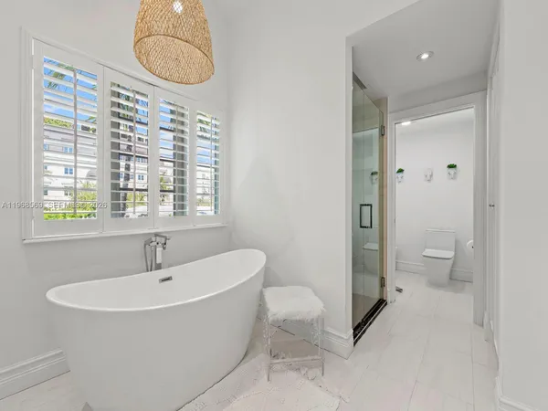 a bathroom with a sink a toilet and a shower