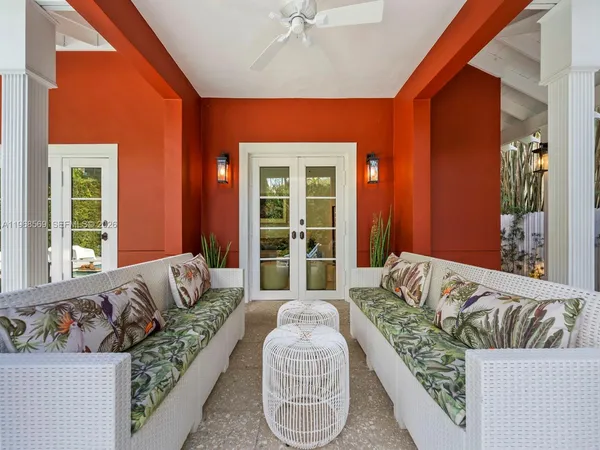 a bedroom with furniture and a large window