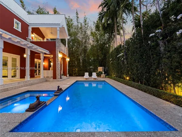 a view of swimming pool is middle in the garden