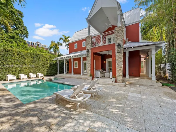 a front view of a building with a garden and plants
