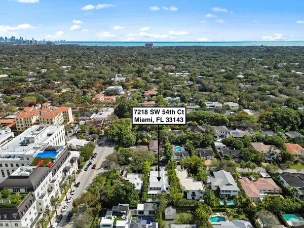 an aerial view of residential building with green space