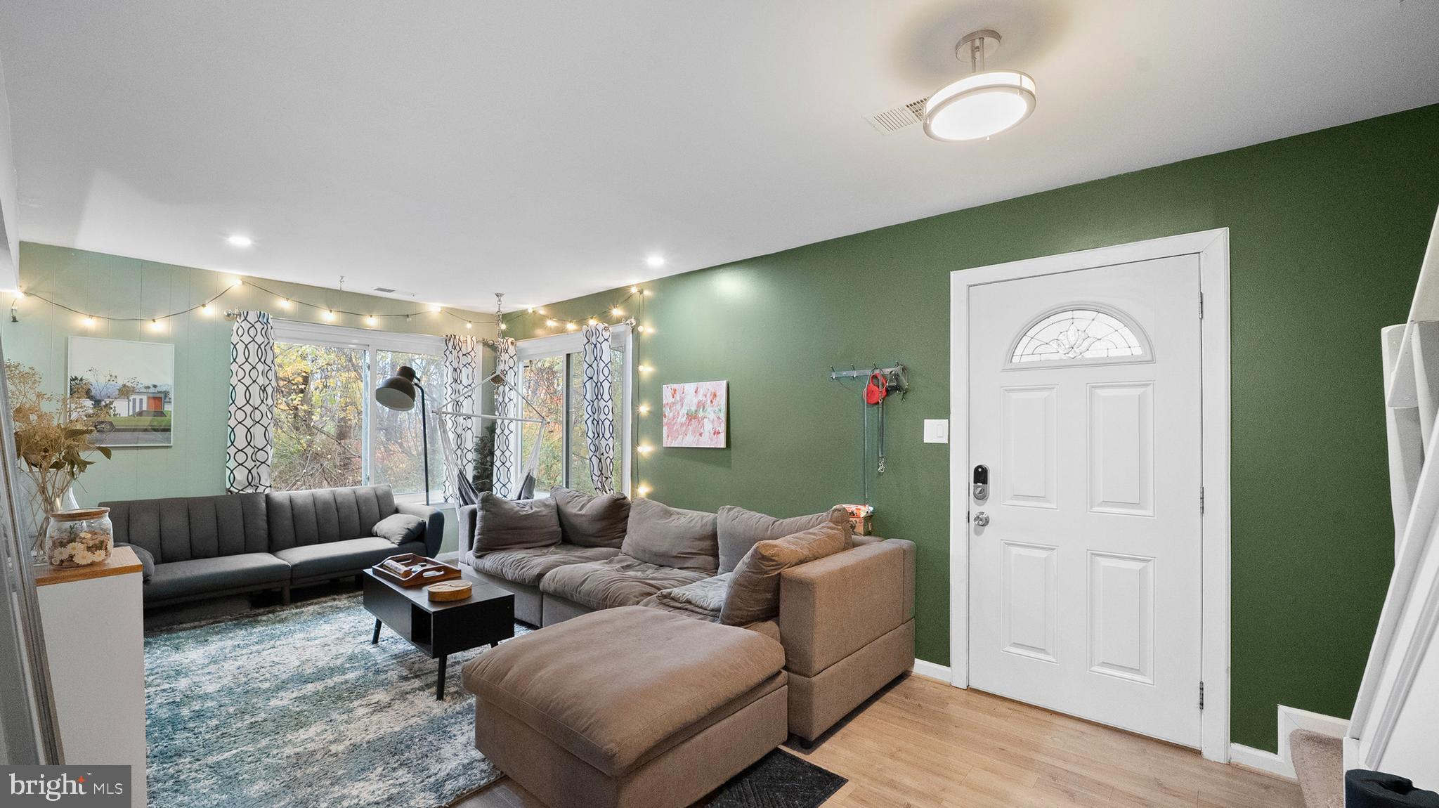 12862 Sage Terrace Germantown, MD 20874 - Photo 17 of 25 a living room with furniture and a wooden floor