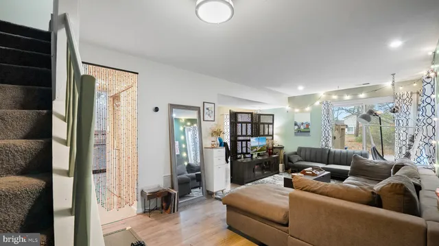 a living room with furniture and a floor to ceiling window