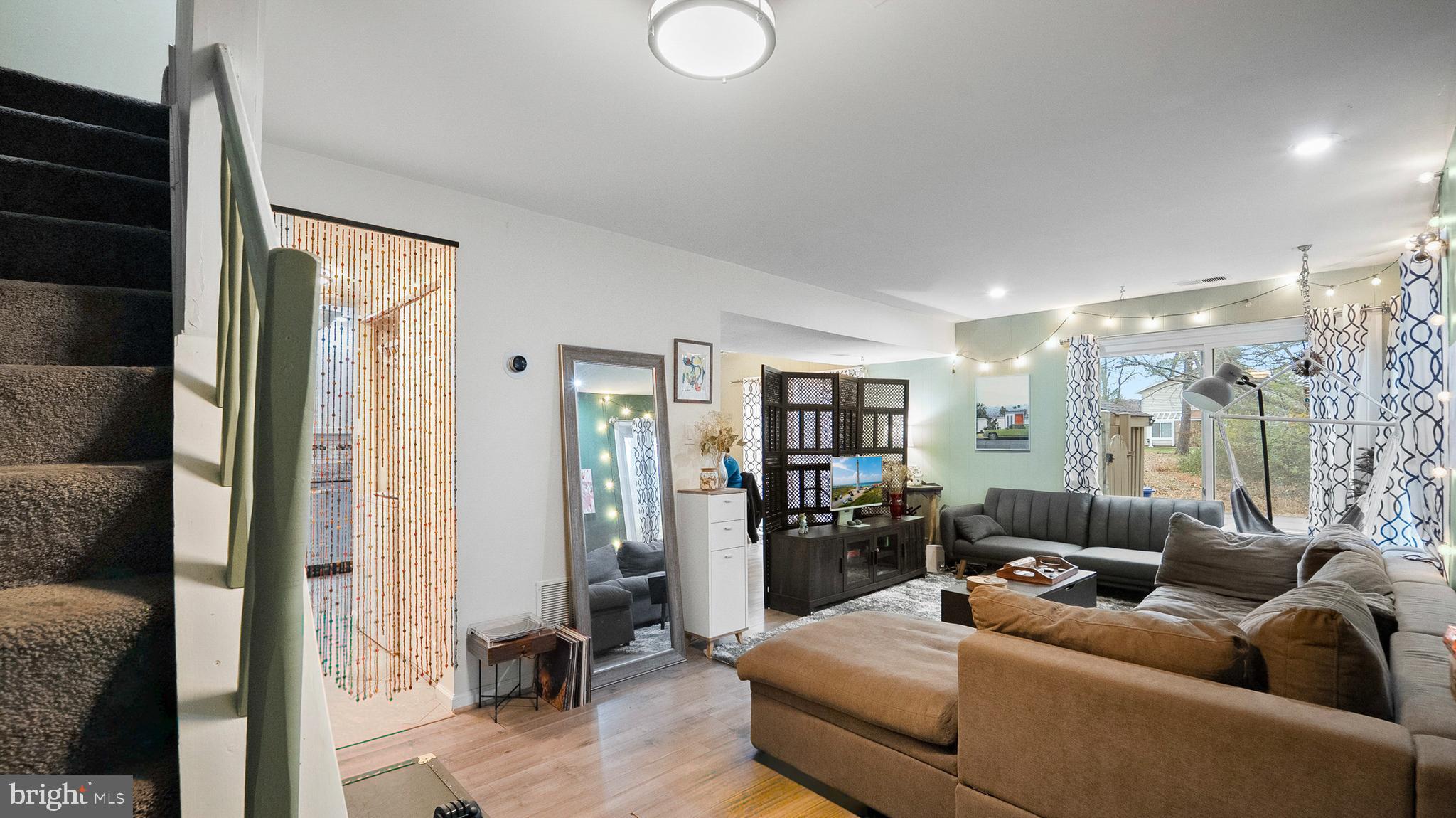 12862 Sage Terrace Germantown, MD 20874 - Photo 18 of 25 a living room with furniture and a chandelier