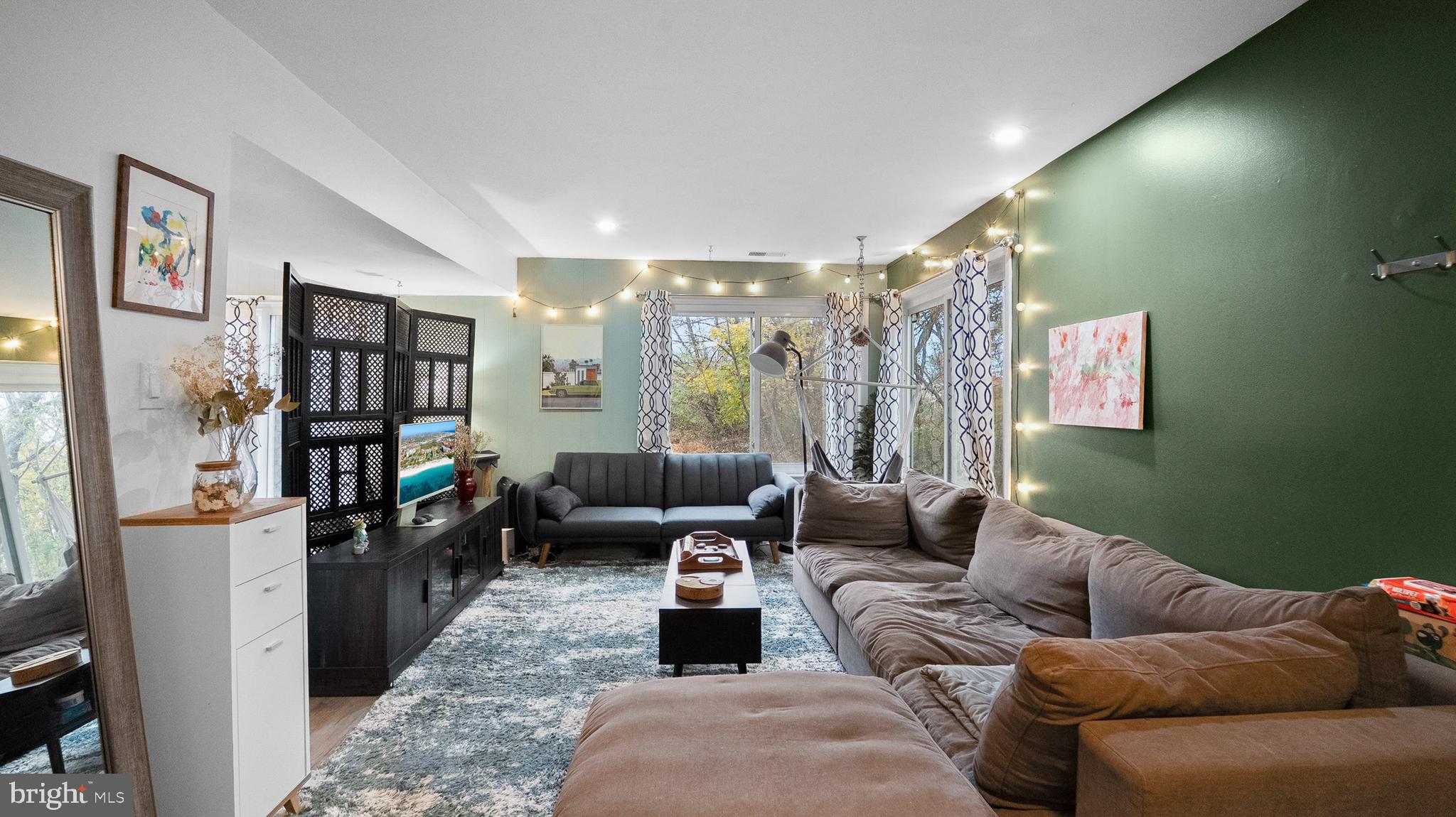 12862 Sage Terrace Germantown, MD 20874 - Photo 19 of 25 a living room with furniture and a floor to ceiling window
