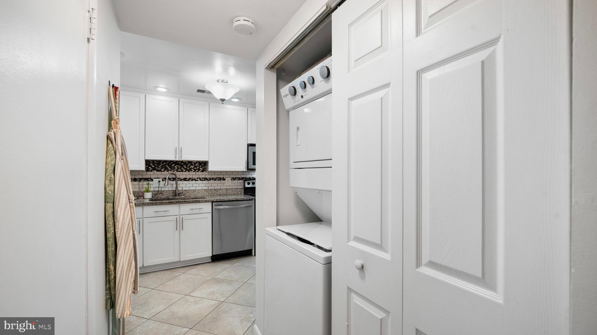 12862 Sage Terrace Germantown, MD 20874 - Photo 24 of 25 a kitchen with a refrigerator and white cabinets
