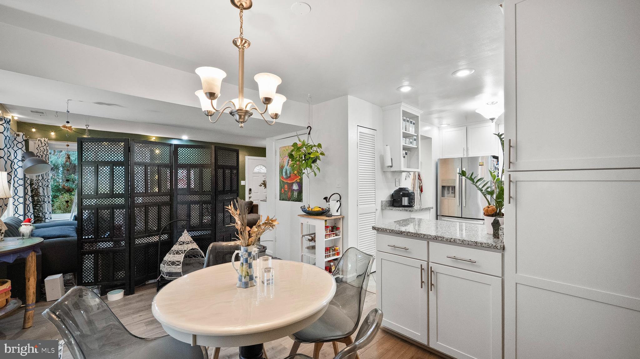 12862 Sage Terrace Germantown, MD 20874 - Photo 5 of 25 a view of a dining room with furniture and a chandelier