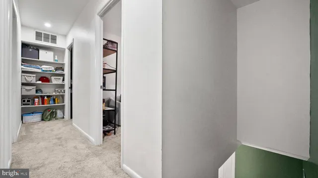 a view of a hallway with shelves