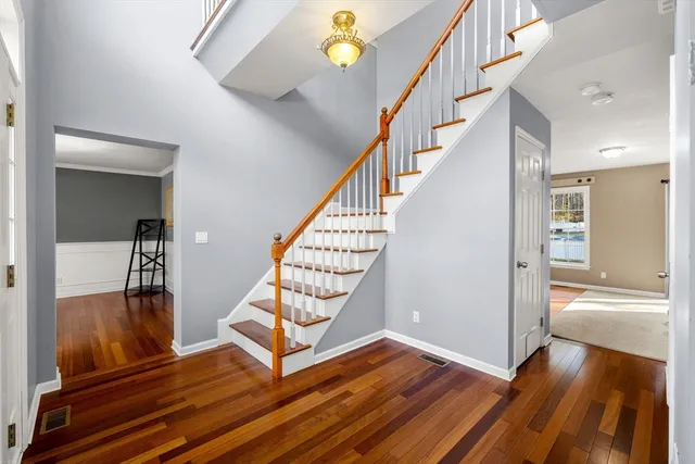 a view of entryway and hall with wooden floor
