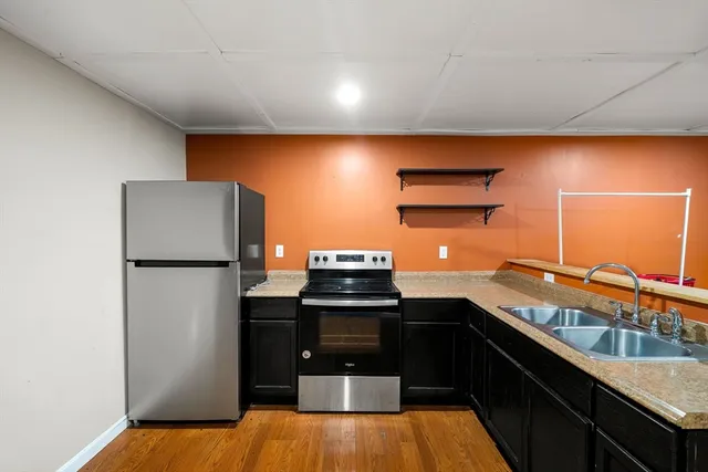 a kitchen with a sink and a refrigerator