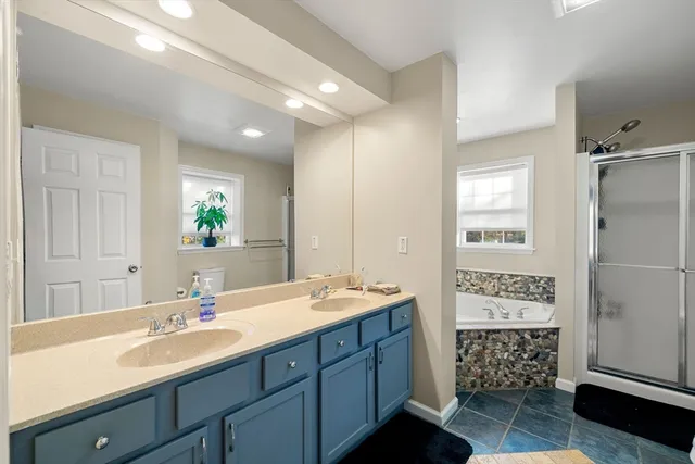a bathroom with a sink a large mirror and a shower