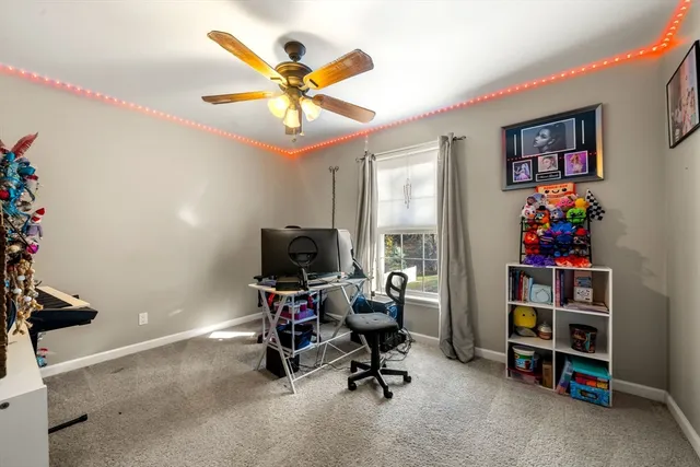 a view of a workspace with furniture and a window