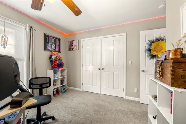 a view of a workspace with furniture and a window