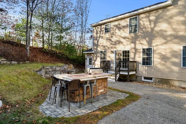 a view of a patio with table and chairs and floor to ceiling window