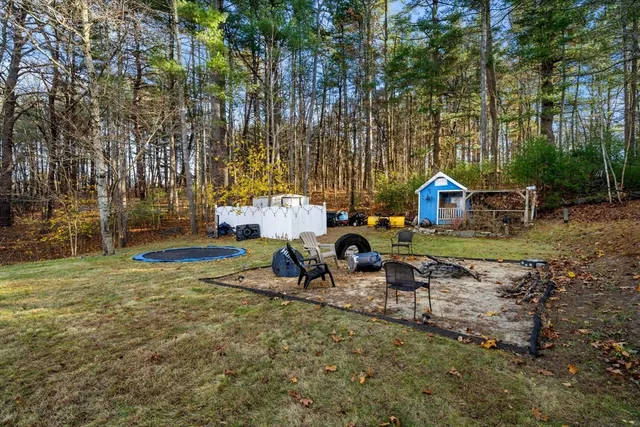 a view of a house with backyard and sitting area