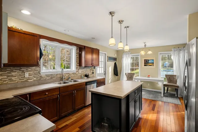 a kitchen with lots of counter top space a sink appliances and cabinets