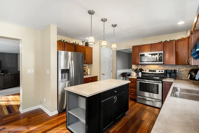 a kitchen with a sink stove and refrigerator
